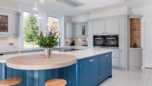 A blue and grey kitchen with shaker doors